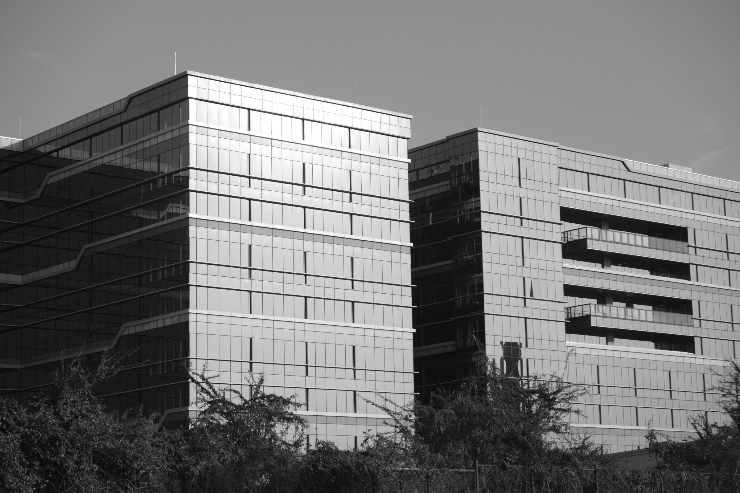 Glass office towers photographed from below in Bengaluru, India; representative commercial setting